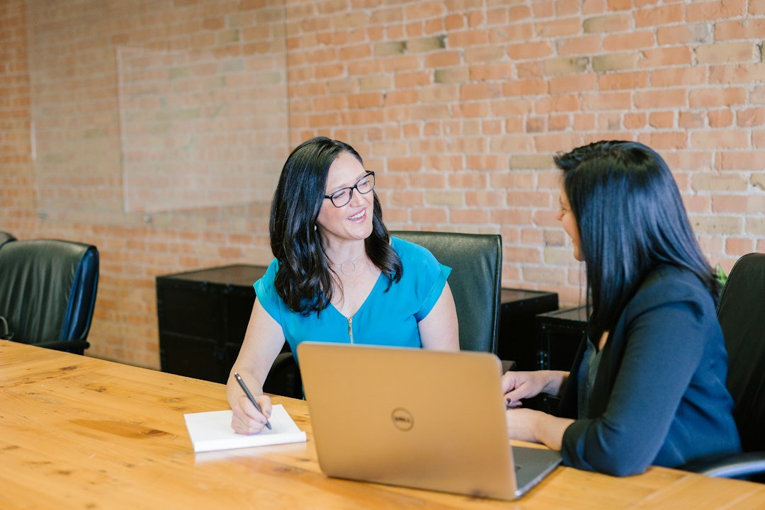 Two professionals reviewing a marketing proposal during an agency consultation