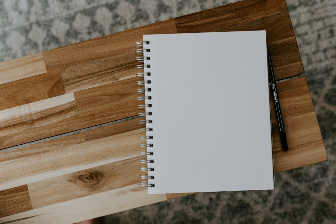 Spiral notebook on a wooden desk used for planning a content marketing strategy