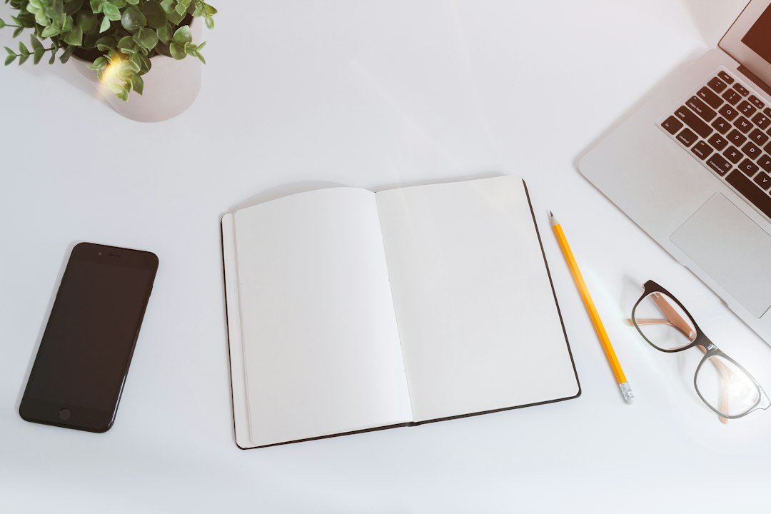 Work table with notes, smartphone and laptop for building an editorial content calendar