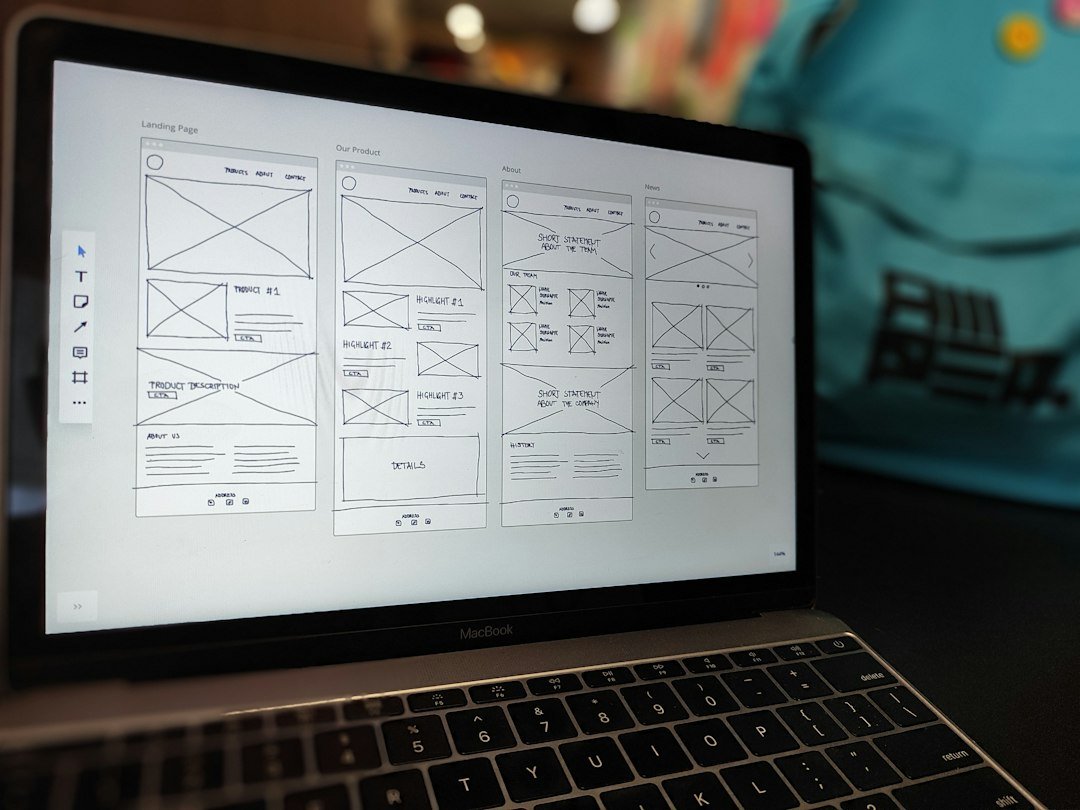 Website wireframe open on a laptop screen on an office desk during a redesign project